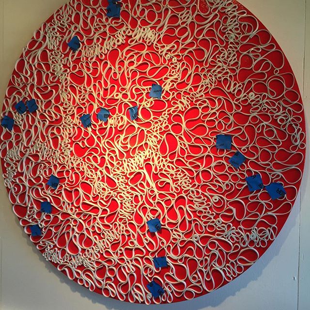 In the studio: blue tape marks the spots where this piece needs some attention. This is a 48" round panel.